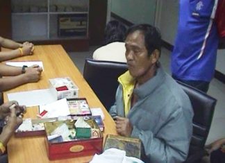 Lilai Piansu checks an inventory of the Buddhist amulets with Pattaya police.